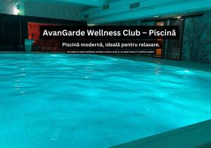 a swimming pool with blue water in a building at Cozy Garden Studio - Free Parking - Wellness SPA in Sinaia
