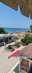 a view of a beach with a building and the ocean at Seaside Studios in Paralia Dionysiou