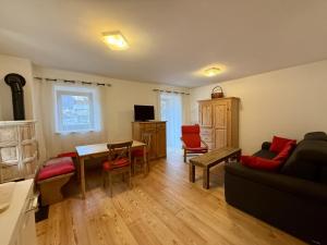 a living room with a couch and a table at Il Molino nel bosco - PT in Alleghe