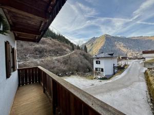 a balcony of a house with a view of a road at Il Molino nel bosco - PT in Alleghe