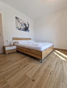 a bedroom with a bed and a wooden floor at Villa Karizma - sea view, swimming pool, hot tub, Brijuni, Fazana, Peroj in Peroj +31 photos