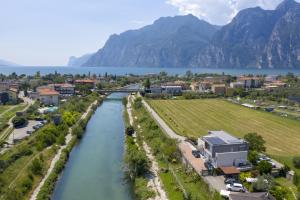 an aerial view of a river with a town and mountains at Appartamenti Villa al Fiume in Nago-Torbole