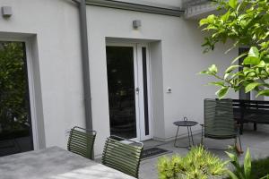 a patio with a table and chairs and a table and chairs at Appartamenti Villa al Fiume in Nago-Torbole +109 photos