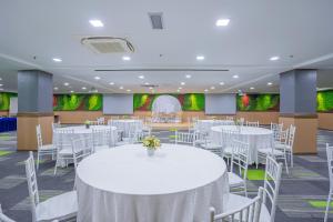 a banquet hall with white tables and chairs at Hotel Olympic Malaysia Kuala Lumpur in Kuala Lumpur