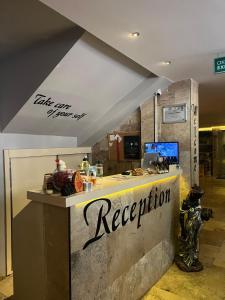 a restaurant counter with the words reception on it at Grand Horizon Apart Hotel in Alanya +28 photos