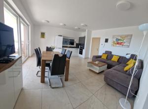 a living room with a couch and a table at Villa Karizma - sea view, swimming pool, hot tub, Brijuni, Fazana, Peroj in Peroj