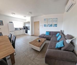 a living room with a couch and a table at Villa Karizma - sea view, swimming pool, hot tub, Brijuni, Fazana, Peroj in Peroj