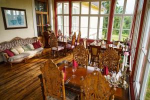a dining room with a table and chairs at Cantervilla Castle in Otepää