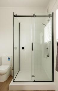 a glass shower in a bathroom with a toilet at The Shed in Cambridge +13 photos