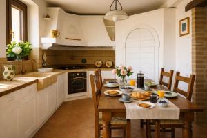 a kitchen with a wooden table with food on it at VILLA ERMELINDA - Ville Carborello in Castelraimondo