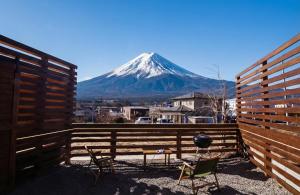 a view of a snow covered mountain behind a fence at SORAPIA Villa Mt.FUJI Front in Fujikawaguchiko