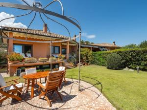 a patio with a table and chairs in front of a house at Estay - Carrubo Oasis - Swimming pool & Garden in Pula