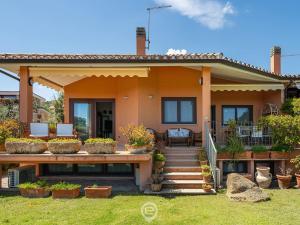 a house with a porch and a patio at Estay - Carrubo Oasis - Swimming pool & Garden in Pula