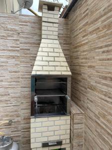 a brick oven in a bathroom with a wall at Casa summer flats 23 Imbassai in Imbassai