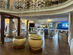 a room with several large white vases on the floor at Hotel Cascade Resort & Spa in Demjén