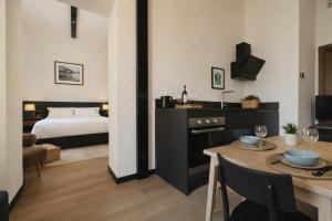 a hotel room with a bed and a table and a room at Cavour Suites in Ancona +84 photos