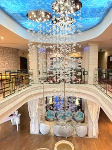 a large room with a chandelier in a building at Hotel Cascade Resort & Spa in Demjén