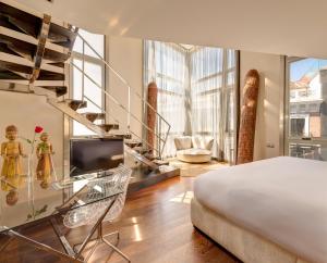 a bedroom with a bed and a tv in a room at Hotel Urban, a Small Luxury Hotel of the World in Madrid +53 photos