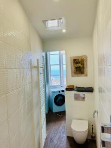 a bathroom with a toilet and a window at Tour XIIIe siècle, vue mer, Cap Corse in Brando +16 photos