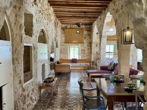 a living room with a large stone wall at Beit El Berbara-Pool & Breakfast in Al Ḩulwah