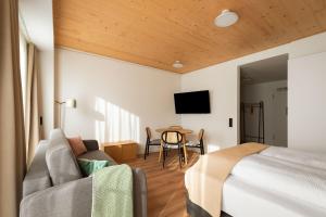 a hotel room with a bed and a table at Limehome Mannheim City Center in Mannheim