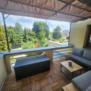 a view of a balcony with a couch and a table at Penzion a Restaurace Simanda in Prague