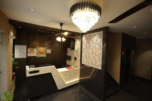 a lobby with a reception desk and a chandelier at Hotel Mantra Inn in Haridwār