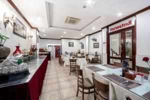a dining room with tables and chairs in a restaurant at A25 Hotel - 44 Hàng Bún in Hanoi