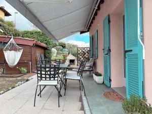 a patio with chairs and a table on a house at @LaCasettasulFiume in Sarnico