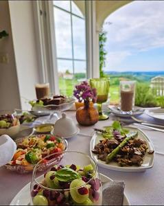 a long table with plates of food on it at Peterc Vineyard Estate in Kojsko
