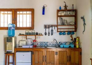 a kitchen with a sink and a counter top at Gecko Cottage - Cosy 2-Bedroom in Bagamoyo Old Town in Bagamoyo +17 photos