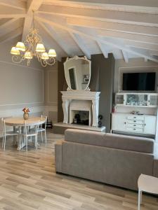 a living room with a couch and a table at Penthouse Apartment Desenzano in Desenzano del Garda