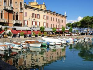 a group of boats docked in a body of water at Penthouse Apartment Desenzano in Desenzano del Garda