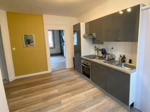 a kitchen with a sink and a counter top at L'Escapade Havraise in Le Havre
