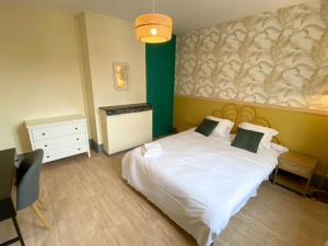 a bedroom with a white bed and a green wall at L'Escapade Havraise in Le Havre +15 photos