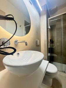 a bathroom with a sink and a shower and a toilet at Kymata Home in Avola +34 photos