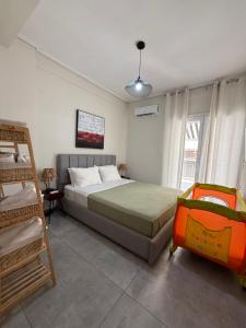 a bedroom with a bed and a ladder at Feels Like Home - Agrinio Suites in Agrinio
