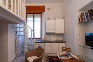 a small kitchen with a staircase and a sink at Appartamento MO in Follonica