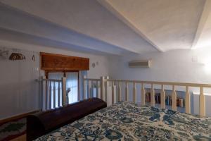 a bedroom with a bed and a stair railing at Appartamento MO in Follonica