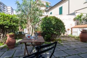 a wooden table with a cup of coffee on it at Appartamento MO in Follonica