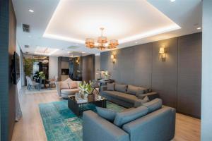 a living room with two blue couches and a table at Wish More Hotel Istanbul in Istanbul