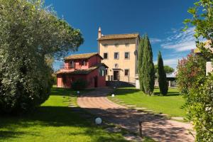 an estate with a large building on a green lawn at Relais Santa Caterina Hotel in Viterbo