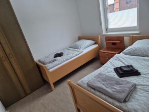 a small room with two beds and a window at Brull in Lengerich