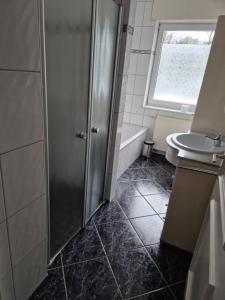 a bathroom with a shower and a sink at Brull in Lengerich
