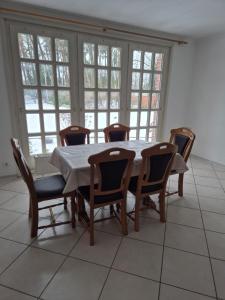 a dining room with a table and chairs and windows at Brull in Lengerich