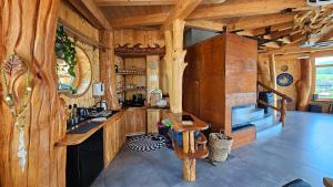 a kitchen with wooden walls and wooden counters at dům Ohně in Prostřední Lánov +9 photos