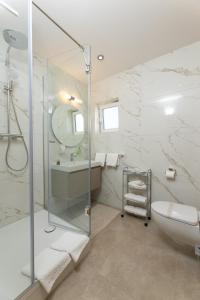 a bathroom with a shower and a toilet and a sink at SEGET ESTATE Beachfront Oasis & Tradition since 1964 - Split Trogir Riviera in Trogir +205 photos
