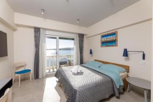 a bedroom with a bed and a view of the ocean at SEGET ESTATE Beachfront Oasis & Tradition since 1964 - Split Trogir Riviera in Trogir