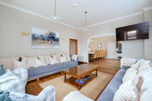 a living room with a couch and a table at Finest Retreats - The Park in Onibury