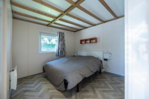 a bedroom with a bed in a room with a window at Camping Domaine Saâne et Mer in Quiberville